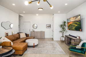 Living room with wood finished floors and recessed lighting