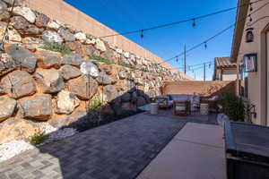 Fenced backyard with a patio and an outdoor living space
