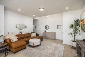 Living room featuring light wood-style flooring and recessed lighting