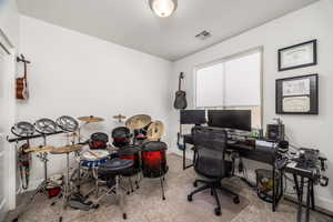 Office with light carpet and baseboards