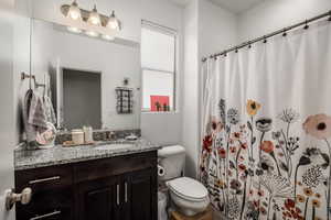 Bathroom with vanity and curtained shower