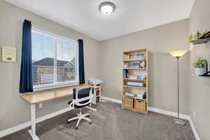 Office space featuring light colored carpet and baseboards