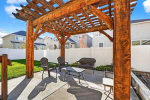 Fenced backyard with a patio area and a pergola