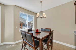 Dining space with a chandelier and light wood-style flooring