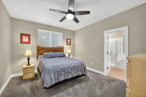 Bedroom featuring carpet, a textured ceiling, ceiling fan, and connected bathroom