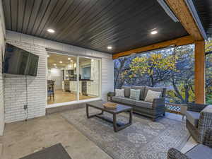 Covered patio with doors leading into kitchen area for easy entertaining