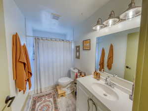 Bathroom featuring vanity, a shower with curtain, and light wood-style floors