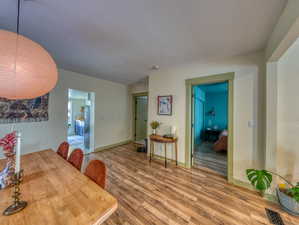 Dining space with wood finished floors and baseboards
