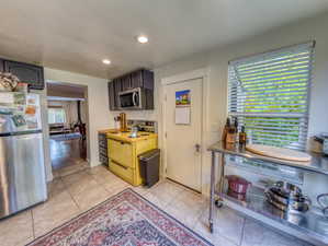 Kitchen with appliances with stainless steel finishes, recessed lighting, light countertops, and light tile patterned floors