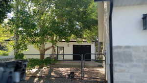 View of side of home with stucco siding and a garage
