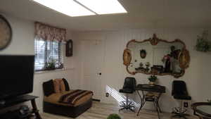 Living area featuring wood finished floors and wooden walls
