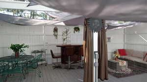 Deck featuring outdoor dining area and an outdoor living space