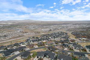 Aerial view of property's location featuring nearby suburban area and a mountainous background