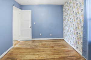 Spare room with wood finished floors and baseboards