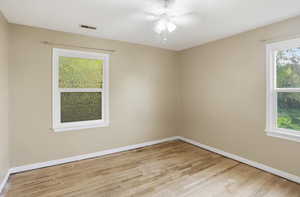 Empty room featuring light wood-style floors and a ceiling fan