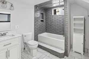 Full bath with vanity, shower / bath combination, and light marble finish floors