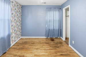 Unfurnished bedroom with light wood-style flooring and a closet