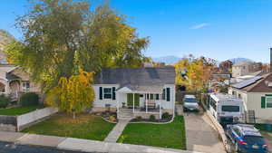 View of front of property with a chimney, a mountain view, and driveway