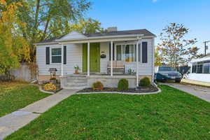 Bungalow-style house featuring covered porch and a front yard