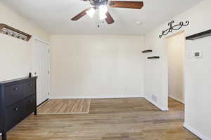 Unfurnished room with light wood-style flooring and ceiling fan