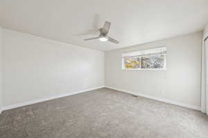 Unfurnished room with light carpet and ceiling fan