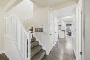 Stairway featuring wood finished floors and baseboards