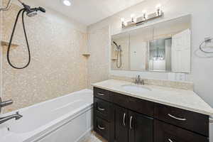 Bathroom featuring bathing tub / shower combination and vanity