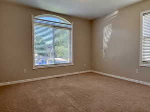 Carpeted bedroom with healthy amount of natural light
