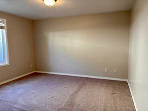 Carpeted bedroom featuring baseboards