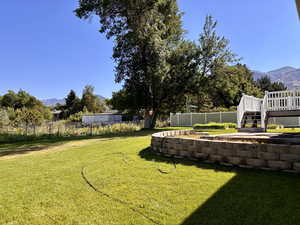 View of yard featuring a deck with mountain view