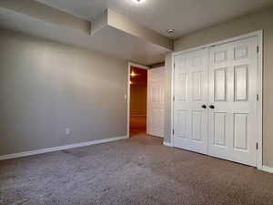 Unfurnished bedroom with carpet and a closet