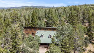 View from above of property with a heavily wooded area