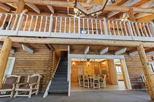 View of patio / terrace with a wooden deck, stairway, and outdoor dining area