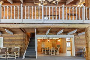 View of patio / terrace featuring a wooden deck, stairway, and outdoor dining space