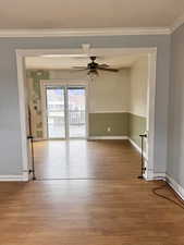 Unfurnished room with ornamental molding, light wood-style floors, and ceiling fan