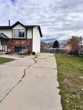 View of home's exterior featuring a lawn and a patio area