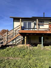 Back of property featuring a wooden deck