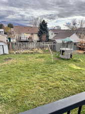 View of yard featuring a playground and a storage shed