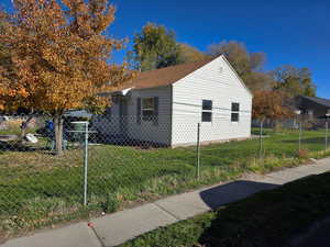 View of side of home featuring a fenced front yard