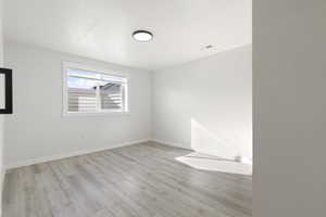 Spare room featuring light wood-style floors and a textured ceiling