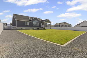 Back of property with a fenced backyard, a gate, and a residential view