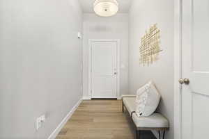 Entryway with baseboards and wood finished floors