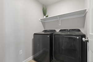 Washroom featuring separate washer and dryer and light wood-style flooring