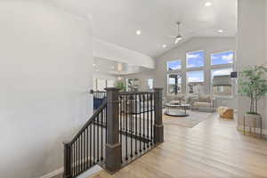 Staircase featuring wood finished floors, high vaulted ceiling, recessed lighting, and a ceiling fan