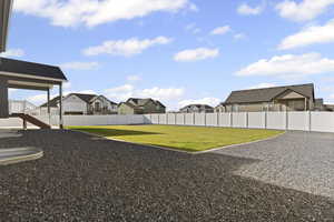 Fenced backyard with a residential view and stairs