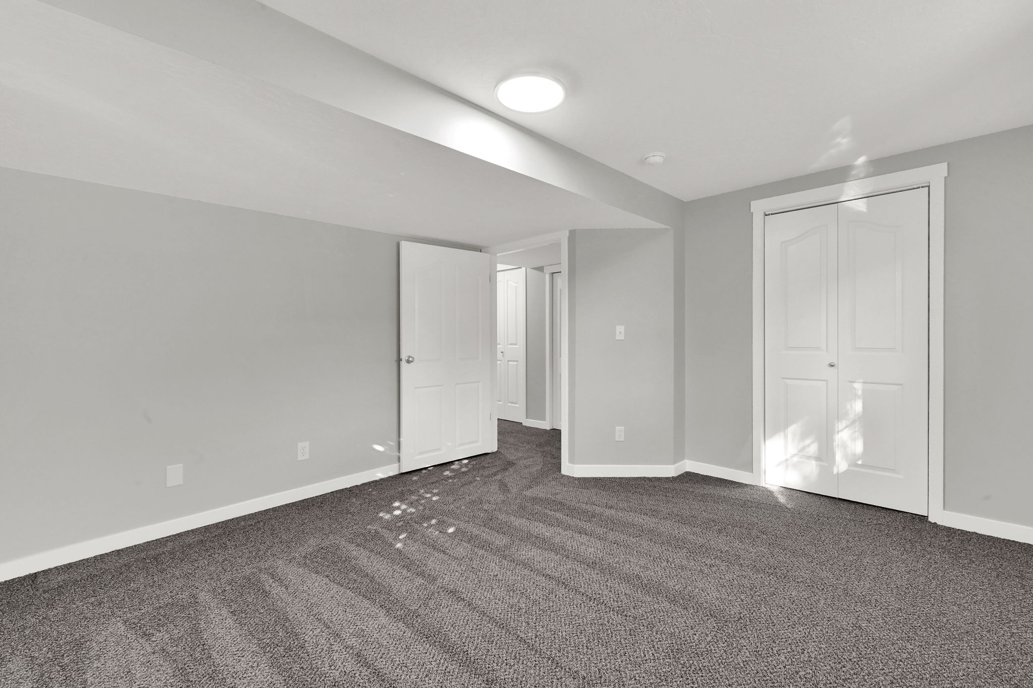 Unfurnished bedroom featuring dark carpet and a closet