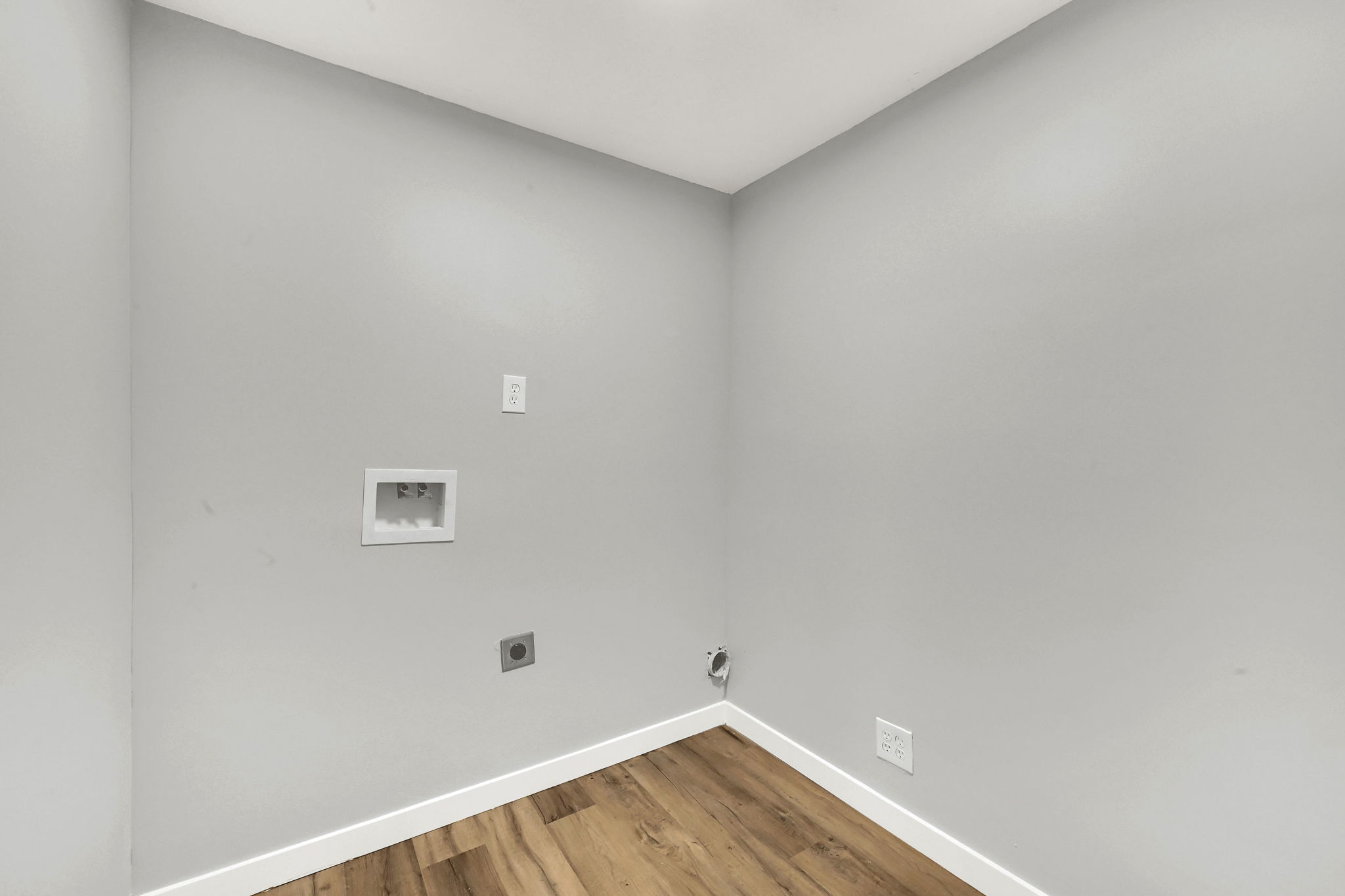 Laundry area with wood finished floors, washer hookup, and electric dryer hookup