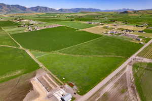 Aerial view of sparsely populated area featuring mountains and large plots for crops