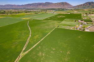 Aerial view of property's location featuring a mountain backdrop and rural landscape