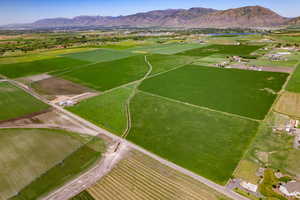 Overview of rural landscape featuring a mountainous background and extensive farmland